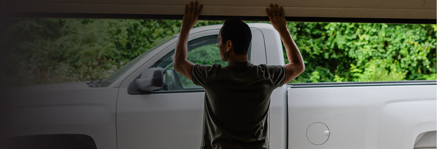 image of man in a garage looking at a truck